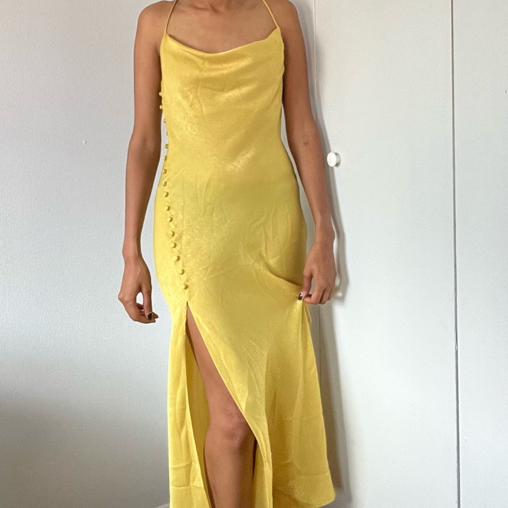 Sleek golden satin dress with button split